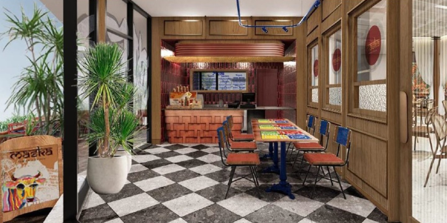 A modern lobby interior with checkered flooring, wooden counter, colorful menus on tables, against a stylish backdrop.